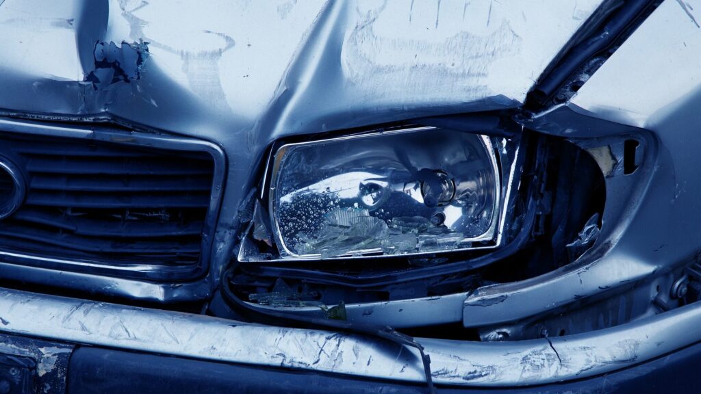 Blue car with front end damage after collision on a blog post from a Houston personal injury lawyer about steps to take after an accident