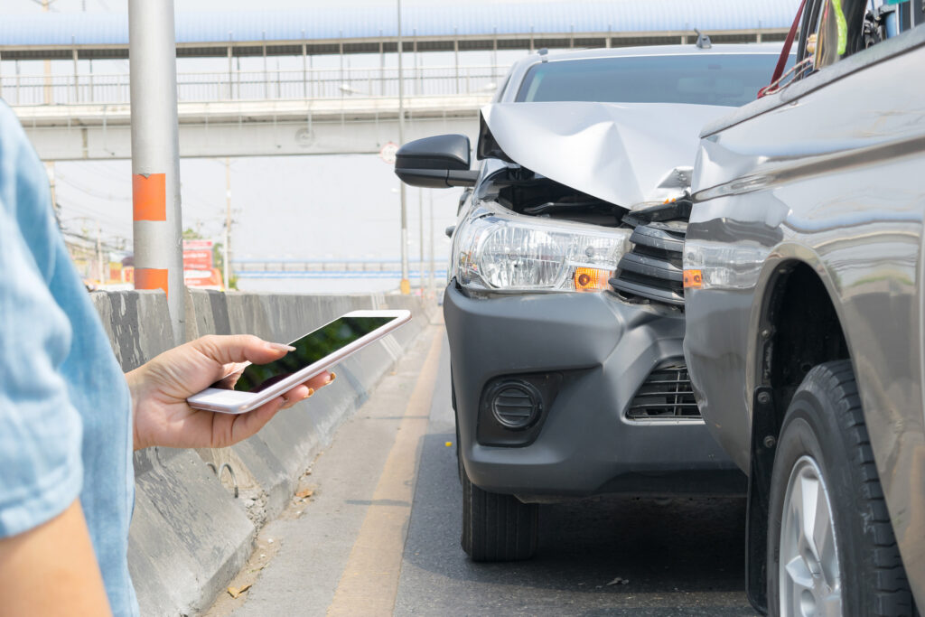 Person calling an auto accident lawyer after a Houston car accident.