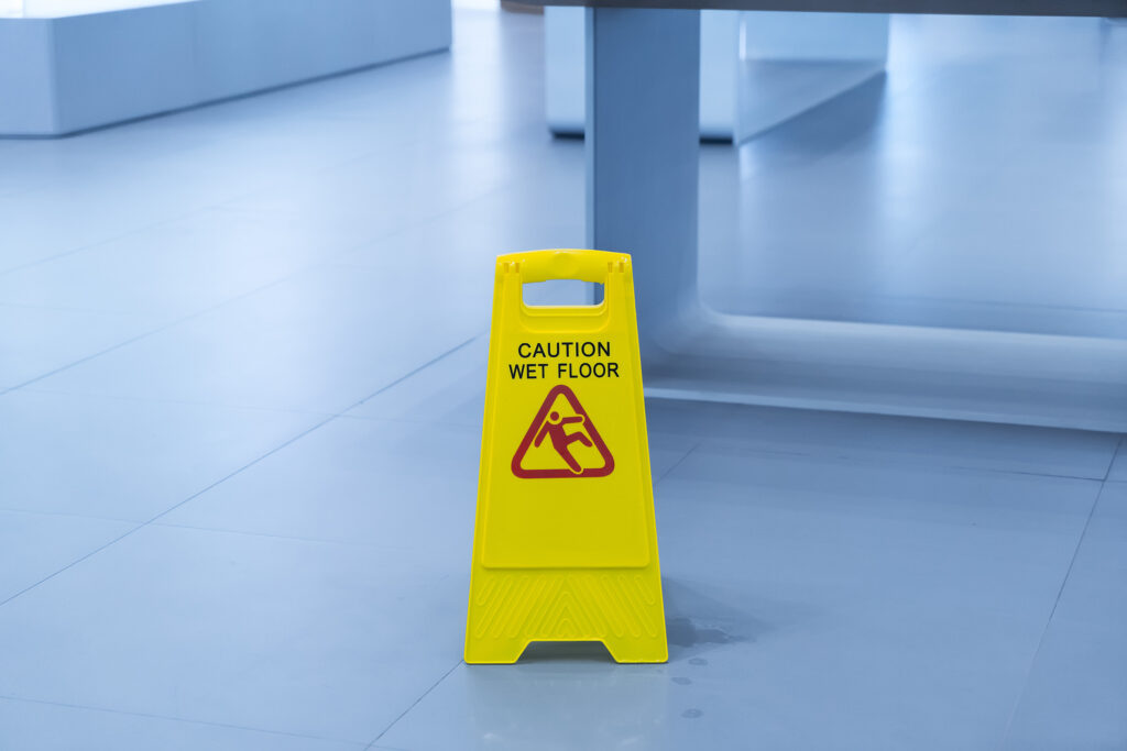  A bright yellow wet floor sign is a good way to keep property visitors safe and avoid premises liability lawsuits. 