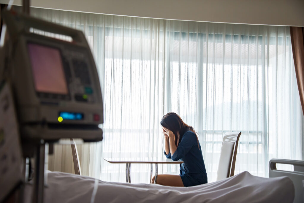 A woman sitting and crying in front of a person lying in a hospital bed. If you’ve lost a loved one due to the negligence of others, a wrongful death attorney in Houston can help you get the justice you deserve.