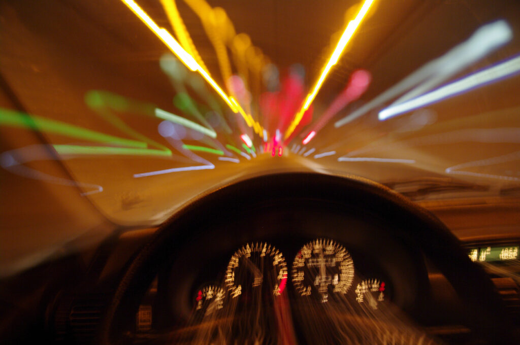 Blurry perspective of person driving car. If you’ve been injured by a drunk driver in Houston, our drunk driving accident lawyers can help you pursue justice.