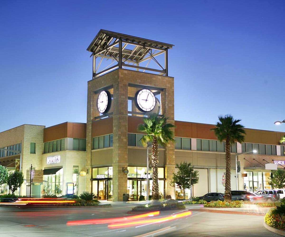 Exterior of a shopping center with a clock tower.