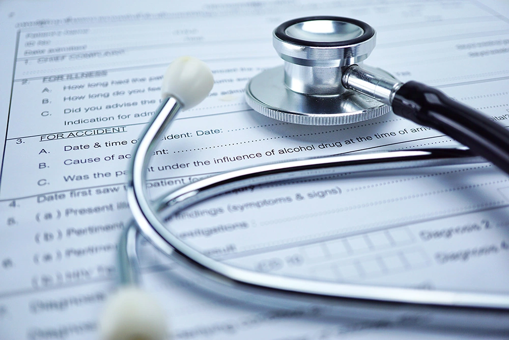Stethoscope sitting on top of a personal injury claim form. If you're suffering from an injury due to negligence, our Houston personal injury attorneys can help you get the compensation you deserve.