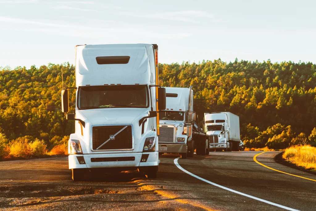 Big commercial trucks parked on the side of the road. if you are involved in an accident with a commercial truck, you should consider contacting a personal injury lawyer.