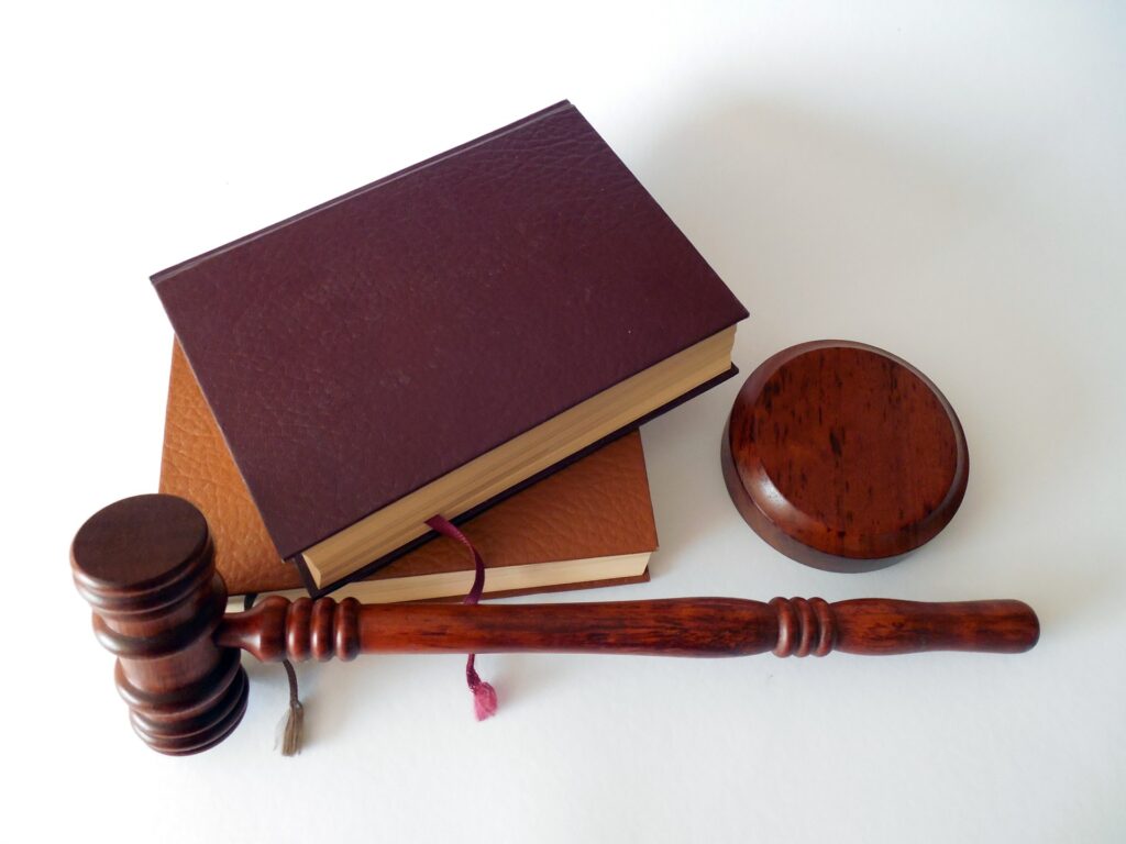 Image depicting a gavel and legal documents, symbolizing a lawsuit in progress.
